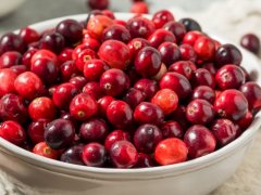white bowl filled with red cranberries